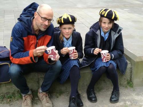 Hereford Cathedral Junior School pupils Bethan N and Isabel N with their dad on World Porridge Day